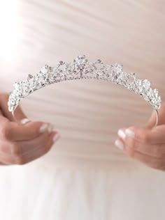 a woman holding a tiara in her hands