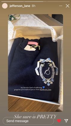 an open box containing a t - shirt and bracelet