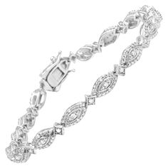 This show-stopping diamond link bracelet is an enviable accessory detailed with the glamour of round diamonds cradled in prong settings, totaling 1/2 cttw with an approximate I-J Color and I2-I3 Clarity. Alternating marquis and starburst shaped links display an enchanting pattern made from .925 sterling silver, and each link is enhanced by the sparkle of diamonds. This bracelet fastens securely with a box clasp. It is 7.25 inches long, best for small and medium sized wrists. Product Features: Diamond Type: Natural White Diamonds Diamond Count: 64 Round-Cut Diamonds Diamond Color: I-J Diamond Clarity: I2-I3 Diamond Weight: 0.50 cttw Diamond Setting Type: Prong Product Gram Weight: 7.56 Grams Metal Type: .925 Sterling Silver Bracelet Length: Fits Wrists up to 7.25 Inches Bracelet Clasp: Box Marquis Bracelet, Diamond Bangle, Diamond Settings, Bracelet Clasps, Diamond Clarity, Round Cut Diamond, Link Bracelets, Sterling Silver Bracelets, Diamond White