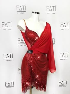 a red dress with sequins on it is displayed in front of a white backdrop