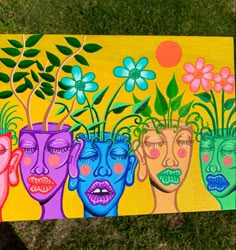 a painting of three people with flowers in their heads and the faces painted on them