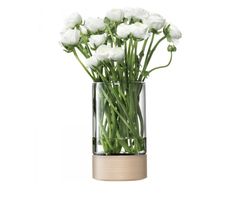 white flowers are in a glass vase with water