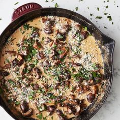 a skillet filled with mushrooms and cheese