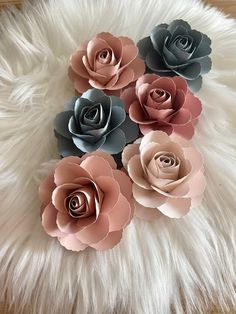 paper flowers arranged on top of white fur