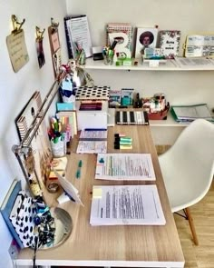 a desk with some papers on it and a chair in front of the desk area