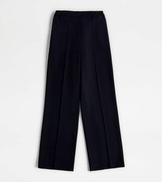 Wide pants in wool with ironed crease. Featuring slanted front pockets and welt back pocket with leather detailing, they are characterized by an elastic waistband. A metropolitan garment with timeless elegance. Classic Pleated Wool Bottoms, Black Wool Bottoms With Welt Pockets, Black Wool Wide-leg Bottoms, Tailored Blue Wool Bottoms, Leather Detailing, Blue Back, Wide Trousers, Blue Trousers, Trainers Women