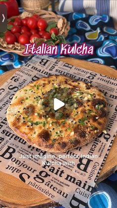 a pizza sitting on top of a wooden cutting board next to tomatoes and other food