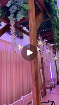 the inside of a building with flowers hanging from it's ceiling