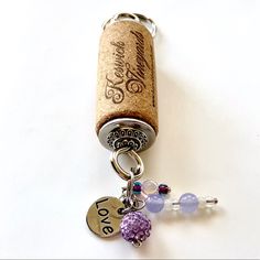 a cork keychain with two charms attached to it