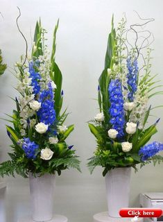 two white vases with blue and white flowers