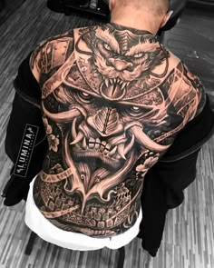 a man with tattoos on his back