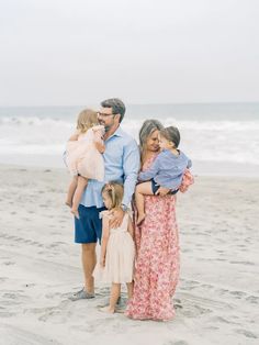 a family standing in the water at the beach