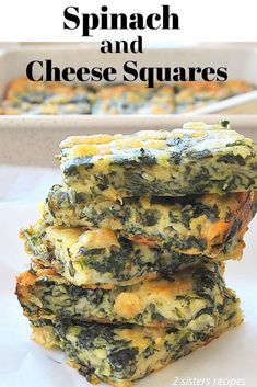 spinach and cheese squares stacked on top of each other in front of a baking dish