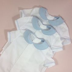 Page boy suit. Lined pale blue cotton shorts with attached braces. Elastic waist, adjustable braces. White cotton short sleeve shirt. Pleat and pin-tuck detail to front. Pale blue Peter Pan collar. Pale blue piping to collar and sleeves. Perfect little suit for any special occasion. Custom orders welcome...please ask. Shirt 6-12m Chest...29.5cm Length from nape to hem...31cm 12-18m Chest...31cm Length from nape to hem...33cm 18-24m Chest...31.5cm Length from nape to hem...37cm 2-3yr Chest...33.5 Blue Fitted Collared Set, Blue Collared Fitted Sets, Blue Short Sleeve Sets For Daywear, Light Blue Fitted Short Sleeve Sets, Classic Blue Short Sleeve Set, Classic Cotton Sets For Summer, Classic Cotton Summer Sets, Blue Cotton Shorts, Blue Peter