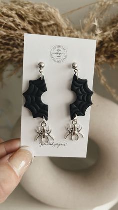 the earrings are black and have bats on them