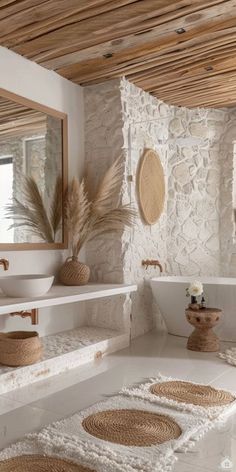 a bathroom with two sinks, mirrors and rugs on the floor