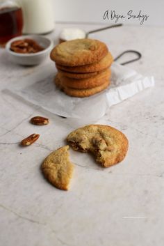 several cookies are on the table with one broken in half