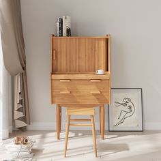 a wooden desk and chair in the corner of a room with a painting on the wall