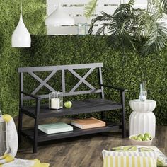 a wooden bench sitting on top of a hard wood floor next to a green wall