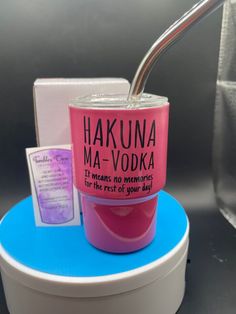 a cup with a spoon sticking out of it sitting on top of a blue stand