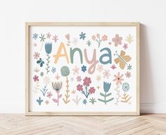 an art print with flowers and the word anya in orange, pink, blue, green