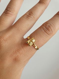 "GUMMY BEAR RING You can get a stylish and cute look with this 90's inspired teddy bear gold plated ring. It can be a gift suggestion that makes you or your loved ones realize the importance of your inner child. YOU MAY ALSO LIKE THESE: https://www.etsy.com/listing/956510530/18k-gold-plated-gummy-teddy-bear-cute https://www.etsy.com/listing/998626958/18k-gold-plated-rabbit-hugging-hands https://www.etsy.com/listing/982521278/18k-gold-plated-butterfly-animal-dainty HOW TO ORDER FROM US ? 1. Click on \"View cart and check out\" 2. At checkout, please fill in your special requests, check if the order is a gift. 3. Choose your shipping method. 4. Enter your payment details and complete purchase. MAINTENANCE OF YOUR JEWELRY - Maintain your jewelry's high shine by avoiding contact with any chemi Teddy Bear Ring, Bear Ring, Gift Suggestions, Thumb Ring, Gummy Bear, Boho Ring, Best Friend Gift, Cute Rings, Plated Ring