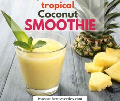 a pineapple smoothie in a glass next to sliced pineapples