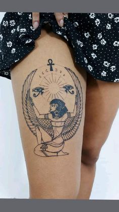 a woman's thigh with an egyptian tattoo design on the thighs and her leg