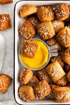 a tray filled with bread rolls and dipping sauce