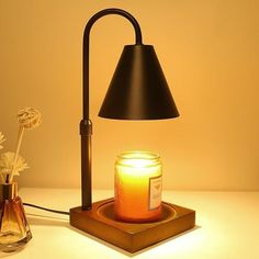 a table lamp next to a jar with a candle on it