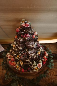 a chocolate cake with strawberries and other toppings