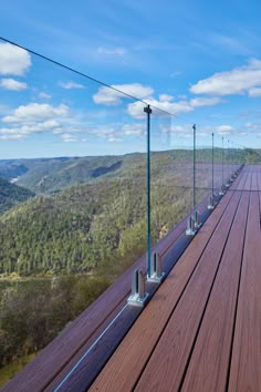 a long wooden deck with metal poles on it