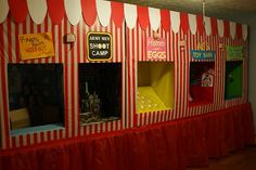 a carnival booth with red and white striped walls