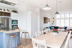 a kitchen and living room are separated by an island in the middle of the room