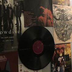 a wall covered in posters and other items from the band's album, slow dive