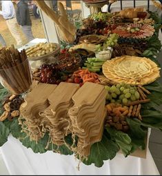 a table with many different types of food on it, including cheeses and crackers