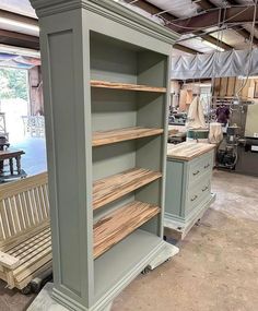 an empty store with shelves and benches in it