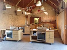 an open kitchen area with several ovens and cabinets on display in the center of the room