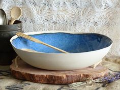 a blue bowl with wooden spoons in it