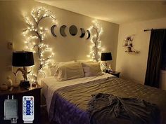 a bed room with a neatly made bed and string lights on the wall above it