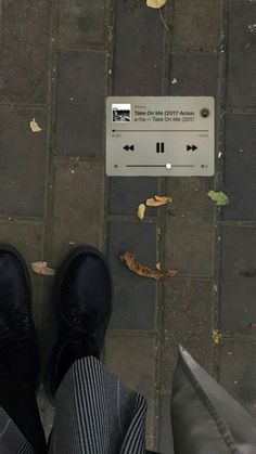 a person standing on the sidewalk with their feet up