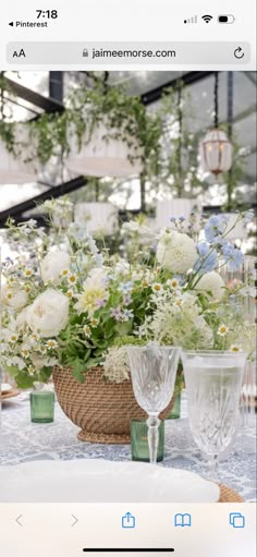 a table topped with vases filled with white flowers