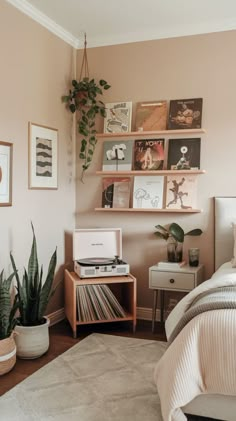 a bed room with a neatly made bed and a plant on the nightstand next to it