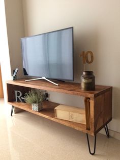 a tv is sitting on top of a wooden shelf