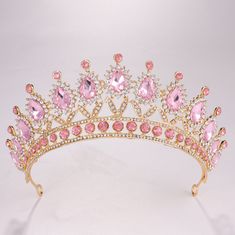 Feature: Princess Crown with pink rhinestone looks charming and exquisite. Vintage Crystal Crown perfect addition for you, enjoy the feel of the princess. Charming and elegant, standout from the ordinary ones. Size:Diameter:15cm/5.9inch.Height:6.5cm/2.55inch. Simply made by sparkly crystal,stable and elegant ,decorates you beautiful and attractive. This queen crown adopts vintage design, stunning and vintage look can make you become the most charming in the prom. Classic crown for women and girl Gold Crown Headband, Crystal Wedding Crown, Crown Pink, Crystal Crown Wedding, Crown For Women, Pink Crown, Beautiful Tiaras, Headband Wedding, Crown Bridal