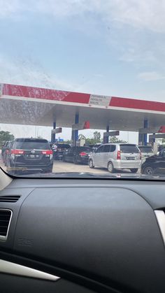 cars are parked at a gas station