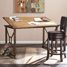 a wooden table sitting on top of a rug next to a black chair and lamp