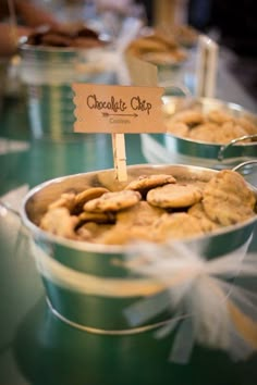 several tins filled with cookies on top of a table