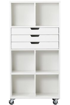 a white bookcase with drawers on wheels