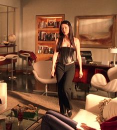 a woman is walking through a living room